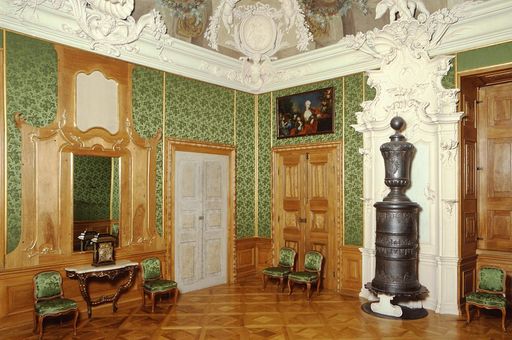 Rastatt Residential Palace, green drawing room with cast iron stove, stucco elements and ceiling frescoes